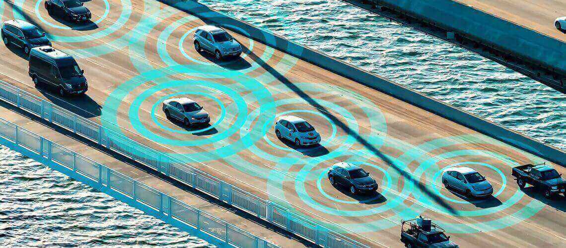 Bridge over sea with cars in motion.